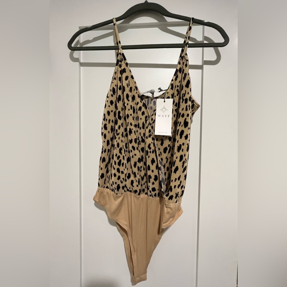 Tan and black body suit. Size M and brand new.